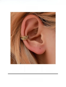 Close-up of a golden hollow leaf ear cuff for non-pierced ears with intricate texture