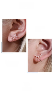Close-up of adjustable leaf ear cuffs with zircon and pearl in rose gold plating