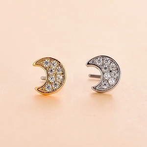 Macro shot of crescent moon nose studs with zircon inlay in gold and silver finish