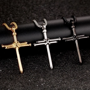 Detailed view of nail cross pendants in gold, silver and black polished alloy metal