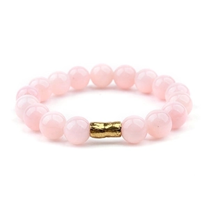 Detail of pink crystal beaded bracelet with a textured gold-tone hammered metal tube