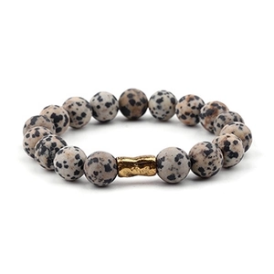 Close-up of Dalmatian Jasper beads and textured gold copper tube on bohemian bracelet