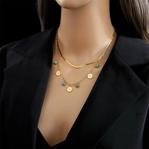 Double-layered gold snake chain necklace with turquoise beads and flower pendants