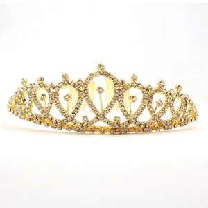 Close-up of golden crown hair comb with sparkling rhinestones and hollow heart design