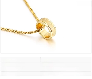 Macro detail of 8mm stainless steel rotating ring pendant on gold box chain