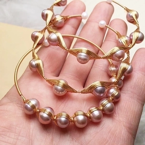 Handmade 14K gold wire wrapped freshwater pearl bracelet with elegant spiral design