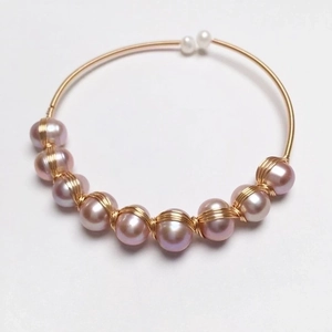 Handmade 14K gold wire wrapped open bangle with elegant purple and white freshwater pearls