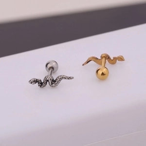 Detailed view of snake-shaped ear studs in silver and gold polished stainless steel