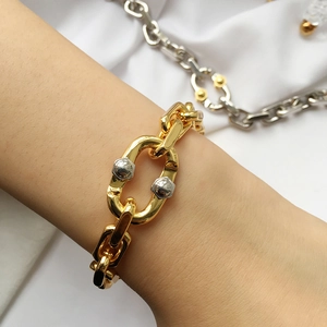 Bold two-tone chunky chain bracelet with gold links and silver bolt accents for unisex style