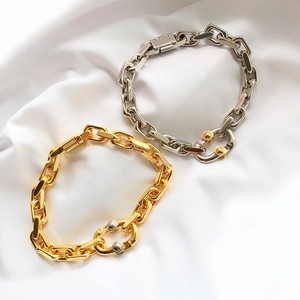 Punk style chunky two-tone gold and silver metal chain bracelet set on white silk