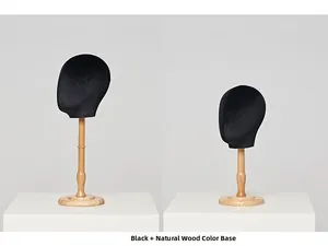 Detail view of black velvet head forms with natural wood stands for hat and wig display
