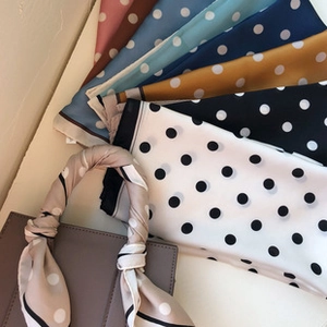 Silk-like satin neckerchiefs in polka dot patterns shown as stylish handbag accessories