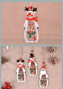 Macro shot of laser-cut wooden Santa and reindeer ornaments with jute twine hanging ropes