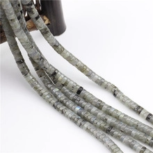 Detailed macro view of natural labradorite disc beads with grey-green iridescent texture