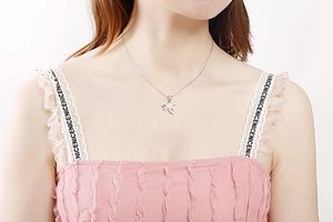 Silver dragonfly pendant necklace displayed on a model with minimalist metal design details