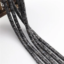 Close-up of square faceted dark grey natural stone spacer beads for jewelry making