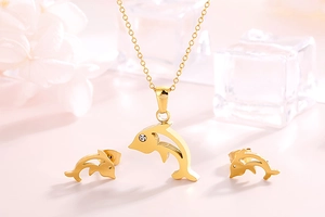 Detailed view of golden fish-shaped jewelry set with crystal dolphin necklace and earrings