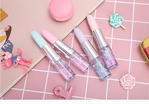 Detail of creative lipstick-shaped pens with flowing liquid glitter and star sequins