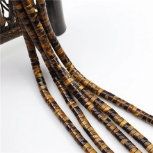 Macro detail of natural tiger eye stone spacer beads with glossy golden brown stripes