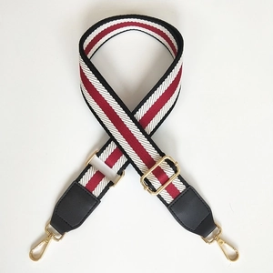 Adjustable woven bag strap featuring red white black stripes and gold metal hardware