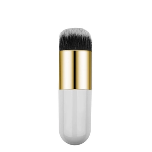 Detail of soft synthetic bristles and gold ferrule of a dual-use makeup brush