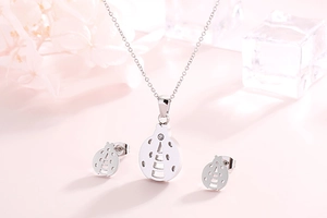 Detailed view of silver ladybug jewelry set with crystal necklace and stud earrings