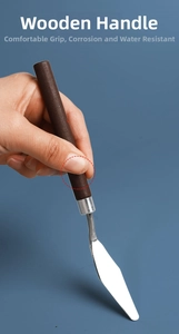Macro view of ergonomic wooden handle on a stainless steel oil painting spatula