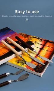Macro view of professional stainless steel palette knives with ergonomic wooden handles