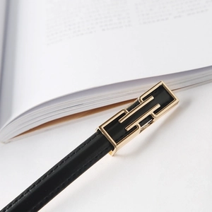 Minimalist black leather skinny belt for women with elegant golden geometric metal buckle