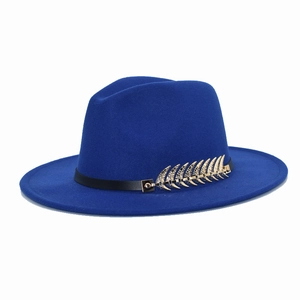 Detail of royal blue wool fedora featuring a gold feather metal accent on a black band