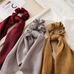 Elegant satin scrunchies with long ribbons in burgundy, grey, and ginger yellow colors