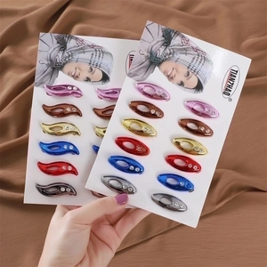 Detail of colorful hijab pins with sparkling rhinestones in leaf and oval shapes