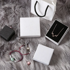 Minimalist black and white jewelry gift boxes with textured paper and matching gift bags