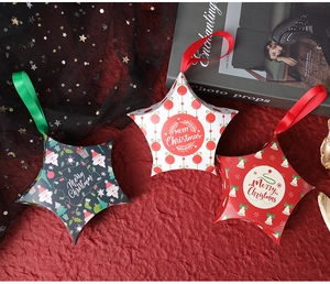 Star-shaped Christmas gift boxes with festive patterns and silk ribbon handles