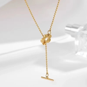Detail of gold flower pendant on beaded titanium steel chain with a secure toggle clasp