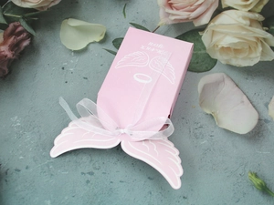 Pink angel wing candy box with white organza ribbon and rose petals decoration