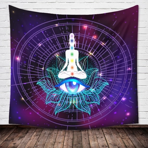Detail of bohemian tapestry featuring a meditating figure with seven chakras and cosmic eye
