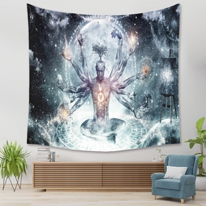 Detail of meditation tapestry with Tree of Life and moon over a blue sofa in a cozy room