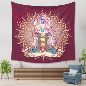 Close-up of bohemian chakra tapestry with golden mandala on deep purple background