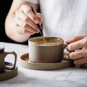 Handmade stoneware coffee cup and saucer set with matte brown rustic sand texture