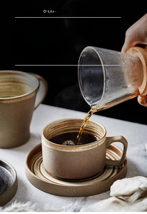 Detailed view of handmade stoneware coffee cup with spiral texture and rustic kiln-change glaze