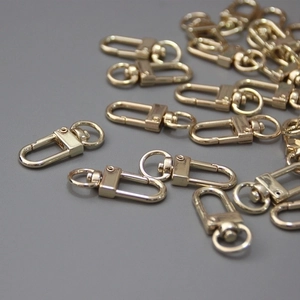 Close-up of golden metal lobster clasp hooks for DIY jewelry and bag chain accessories