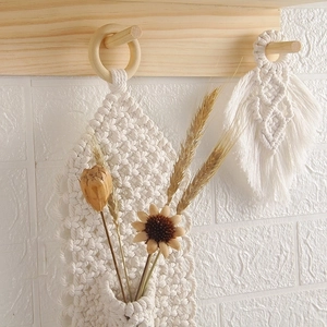 Bohemian macrame wall hanging with handwoven cotton rope tassels and wooden ring decor