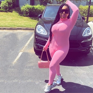 Close-up of pink long sleeve tight jumpsuit featuring a stand collar and front zipper