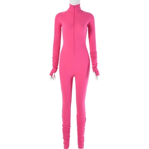 Detail of pink ribbed jumpsuit featuring front zipper closure and ruched sleeve textures