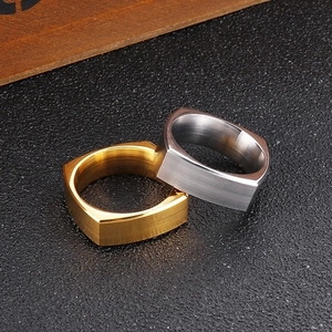 Macro shot of gold and silver square stainless steel rings with brushed metal texture