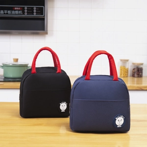 Insulated Japanese lunch bags in black and navy with red handles on a wooden kitchen counter