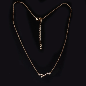 Elegant gold Big Dipper zodiac necklace with sparkling zircon stones on black background