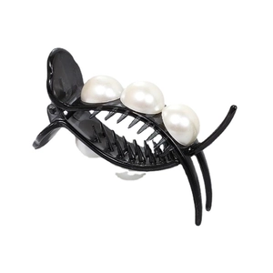 Elegant black hair claw clip with three large white pearls on a clean white background