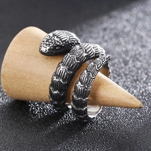 Macro detail of dark stainless steel snake ring showing intricate scale textures